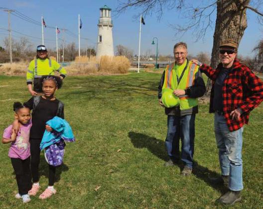 City of Toledo workers, shown here with two young admirers, were able to take advantage of the recent good weather and worked on trimming and clearing the landscaping around the Point Place lighthouse. There is more work to be done when the weather cooperates, so keep watching as the lighthouse is prepared for the spring growing season.